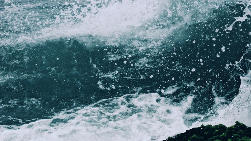 the ocean waves are crashing over the rocks