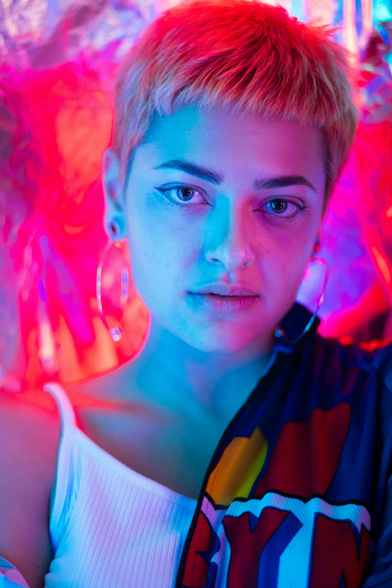 a woman in the neon light, posing for the camera