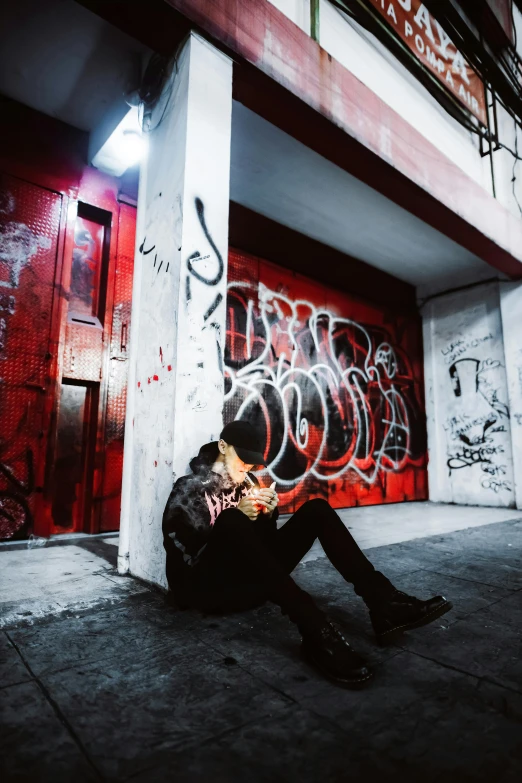 a man sits on the ground while taking his picture