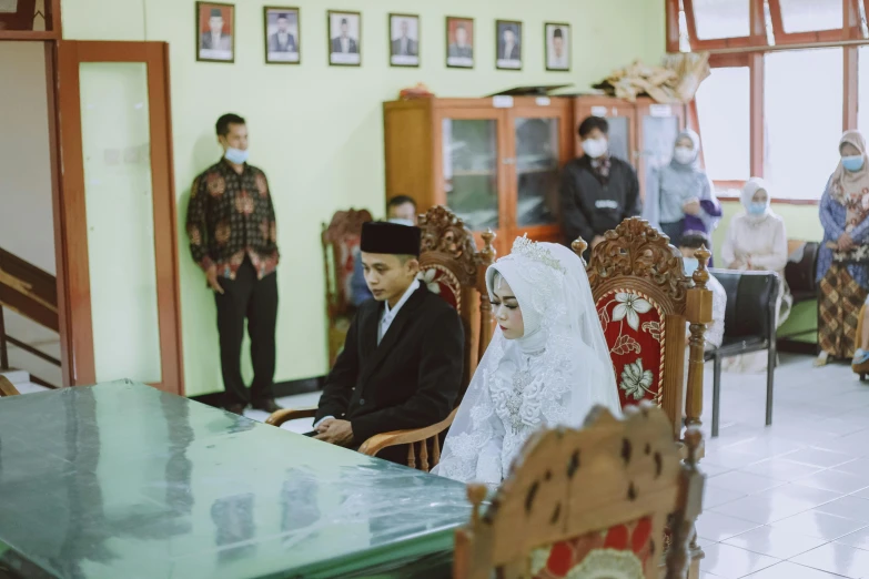 a group of people sitting around a dining room table