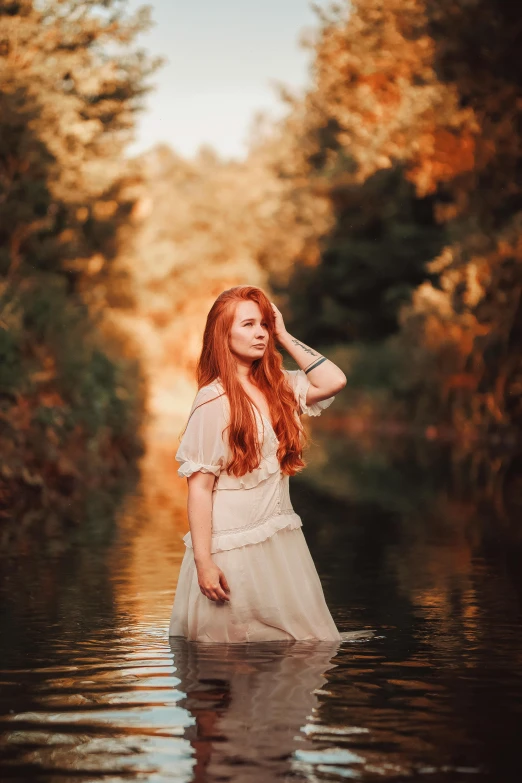 the girl in the long dress is posing for the camera