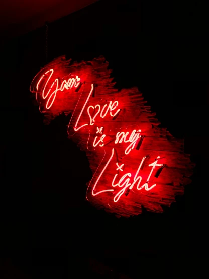 red neon signs are lit up on the wall