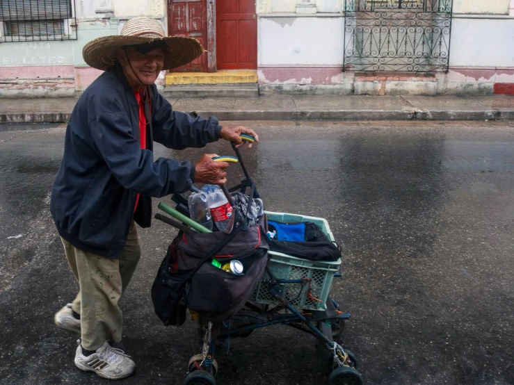 an elderly man hes a basket with luggage in it