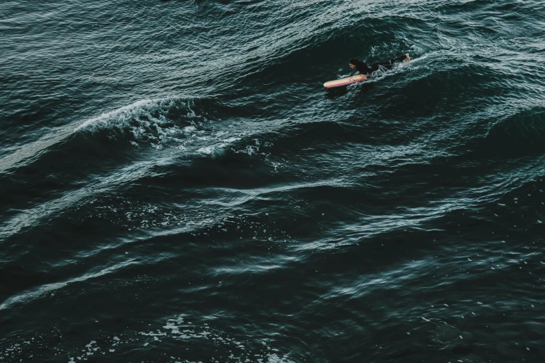 a lone surfer rides a wave in the ocean