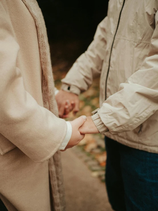 an image of two people holding hands together