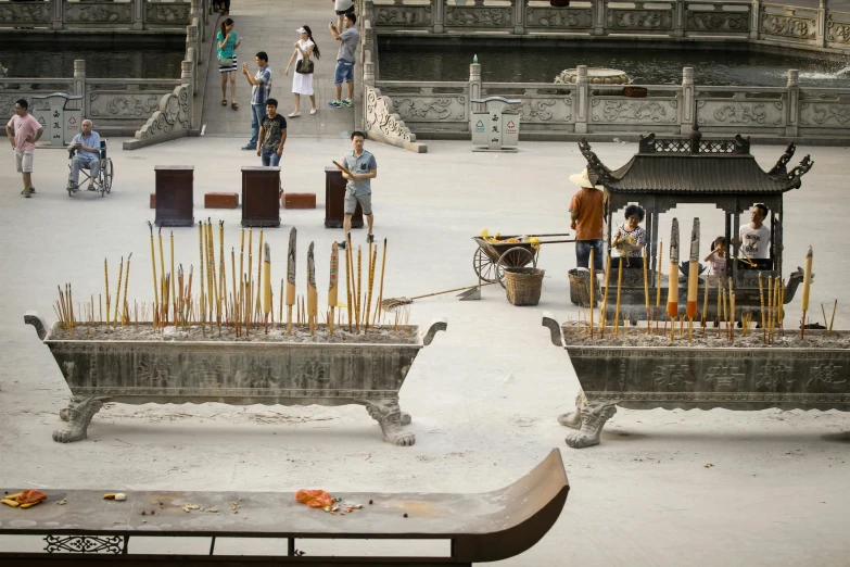 people are standing near a small courtyard with lots of trees