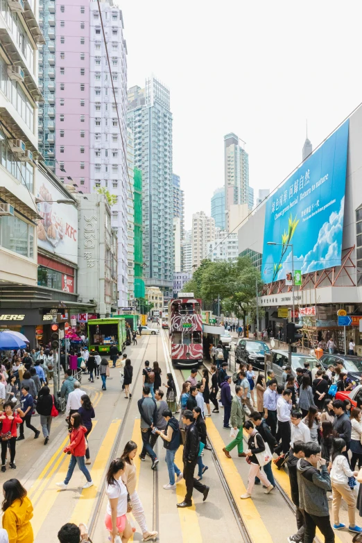 people crossing the street in a crosswalk on a city street