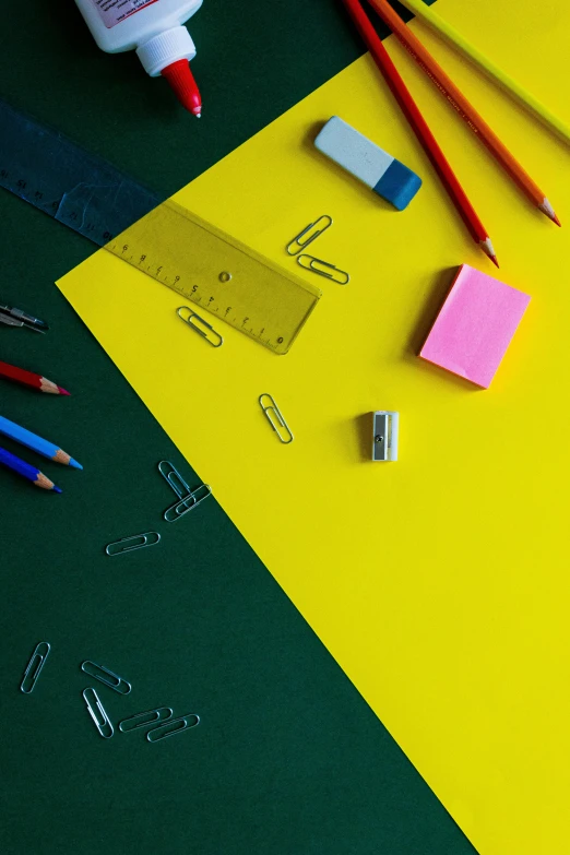 the paint is on a colorful surface beside a pair of scissors and pencils