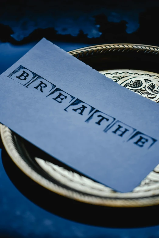 a blue plate with a gray card on it