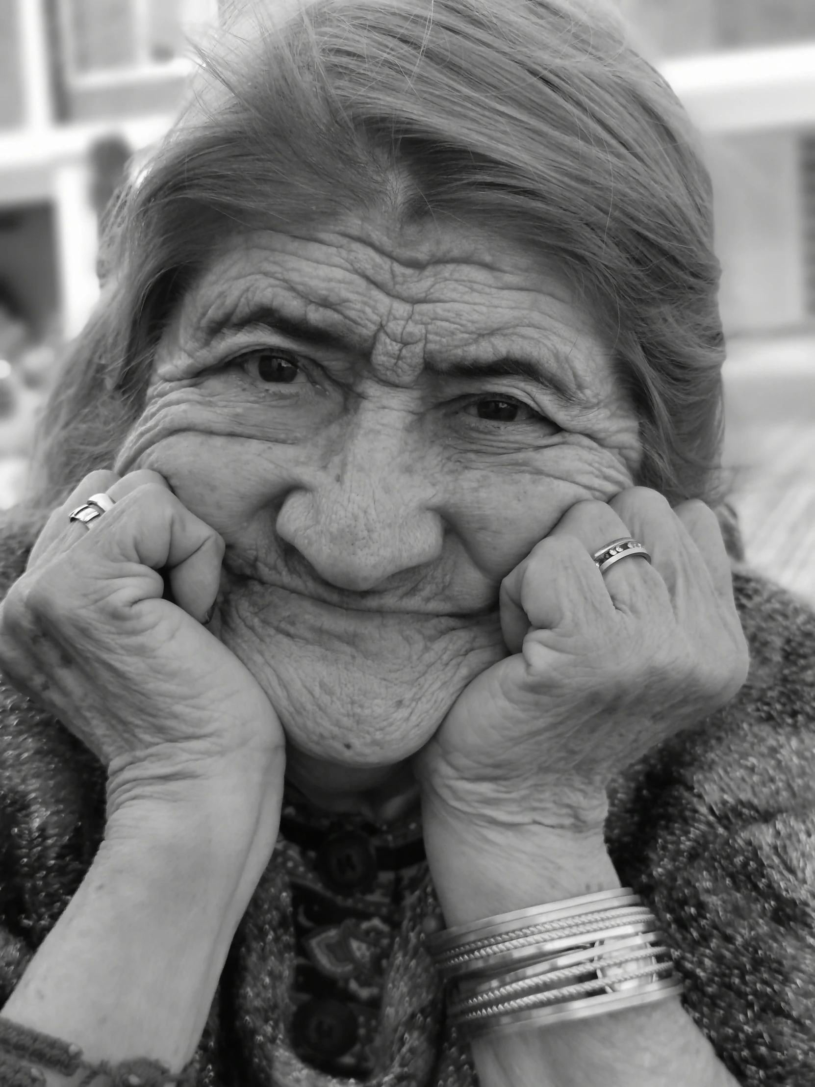 a woman smiles as she covers her face with her hands