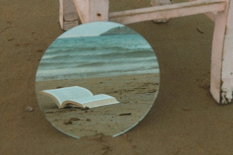 a round mirror sitting on top of a table