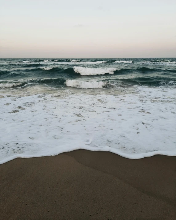 waves coming to the shore of an ocean