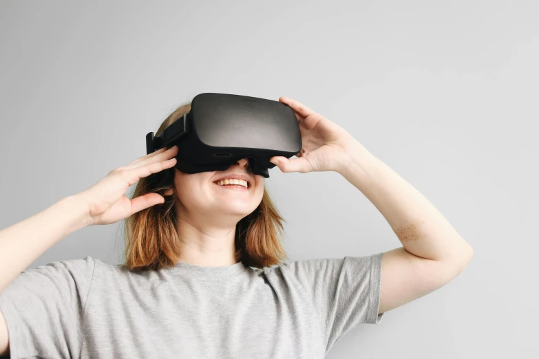 a woman looking at a black video game projector