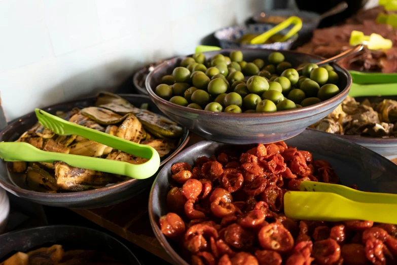 there are many different bowls filled with different foods