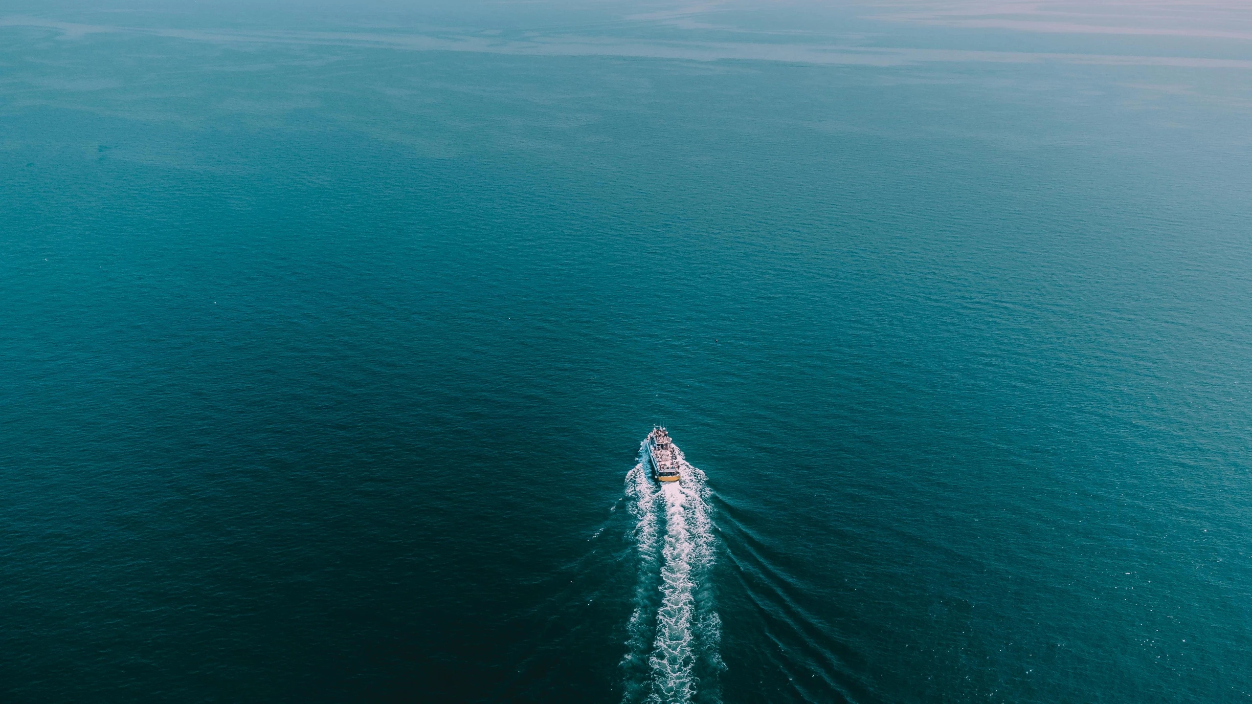 an aerial view of people on skis riding in the water