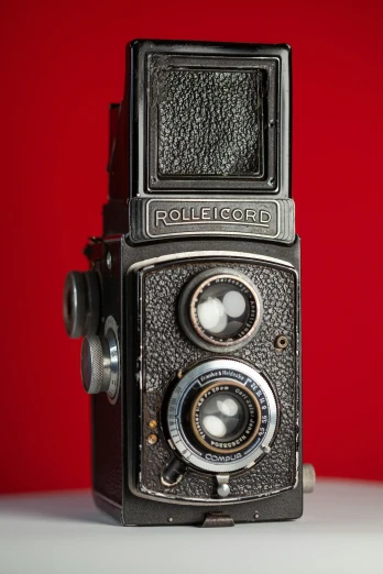 an old antique camera on a white table