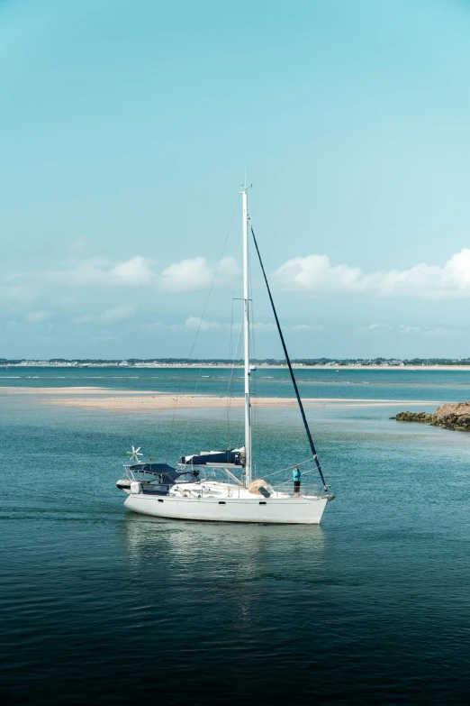 a boat out in the ocean is heading towards the shore