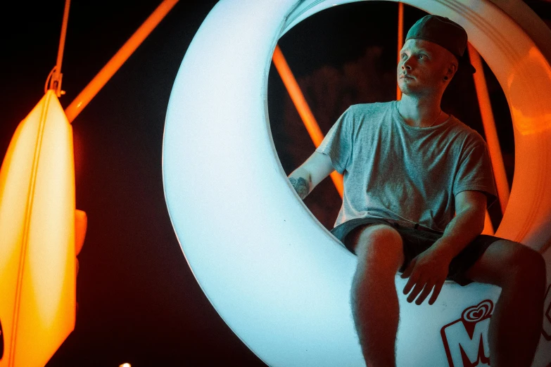 a boy sitting on top of an inflatable object