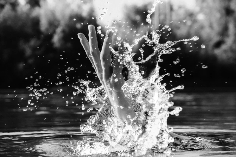 water splashing off of a woman's face into the ocean