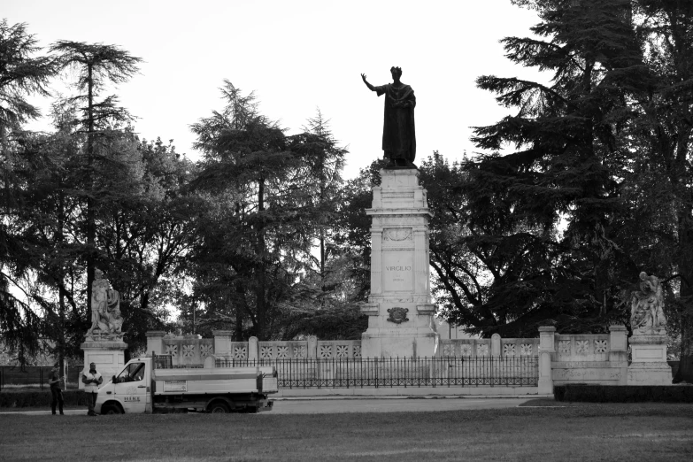 the statue is next to a truck on a park