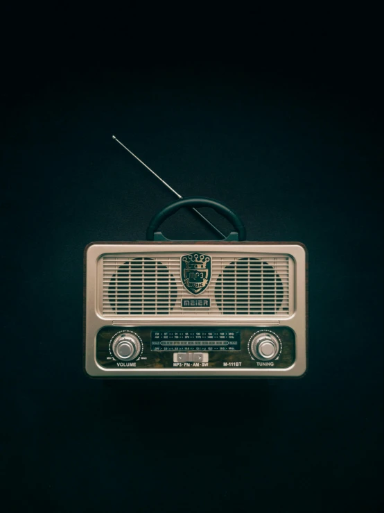 an old model radio set is placed on a black background
