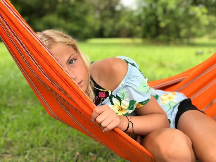 girl sitting in hammock looking out into the distance