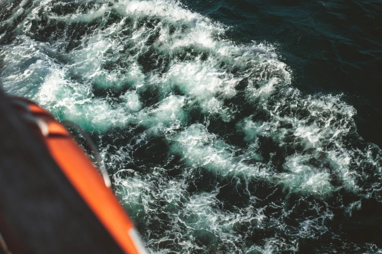 an orange life jacket floating over the ocean