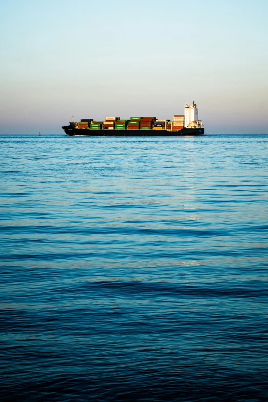 a big container ship floating on top of the water