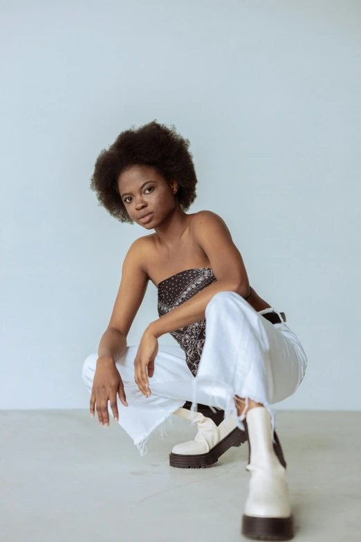 a young woman crouching down on the floor