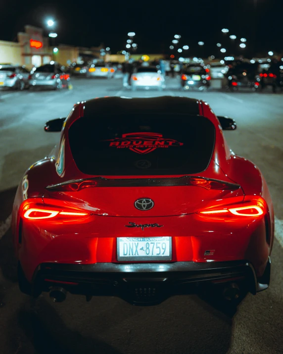 a red sports car parked in a lot