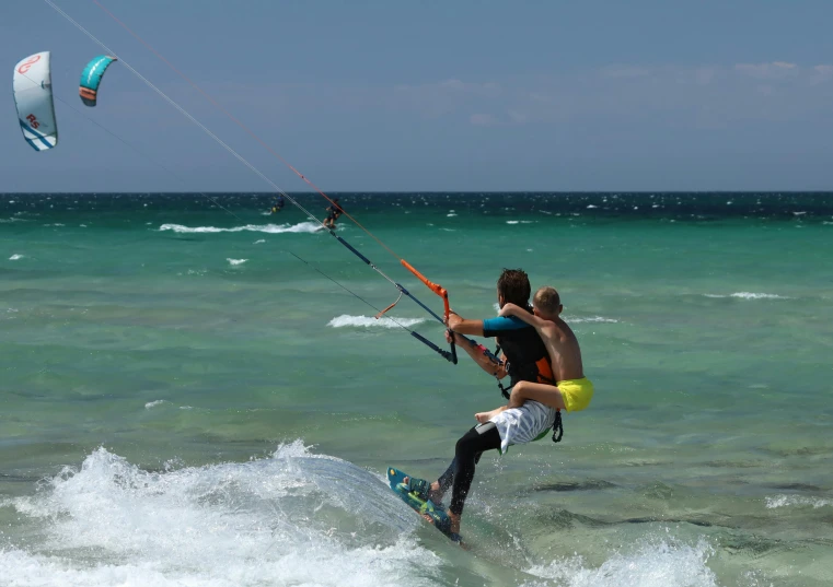 two young people that are surfing in the ocean