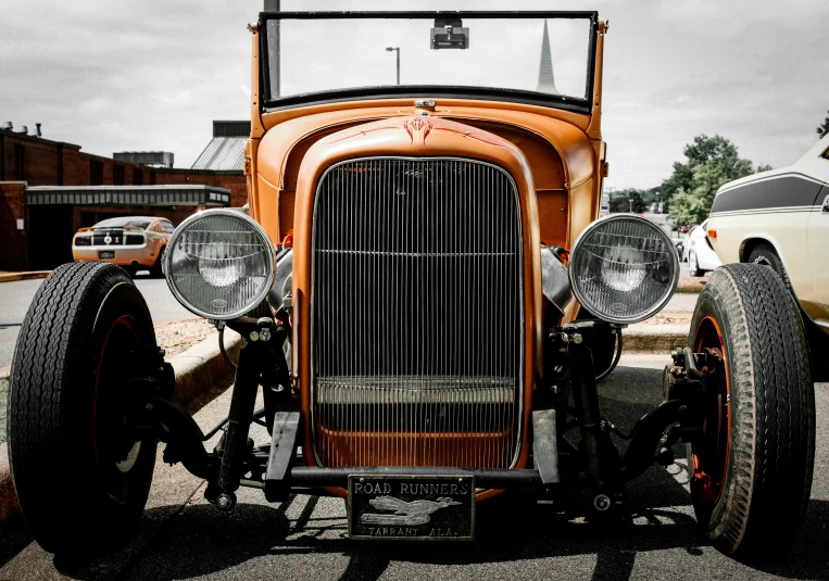 an old time antique car sitting on the side of the road