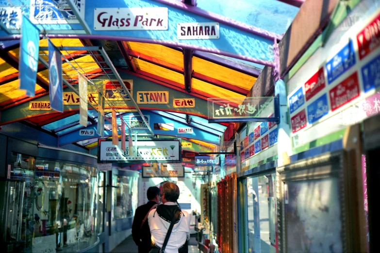 a woman and a man walking in a shopping mall