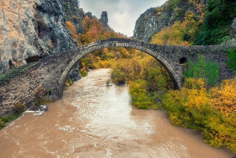 the view of an old stone bridge from a very high angle