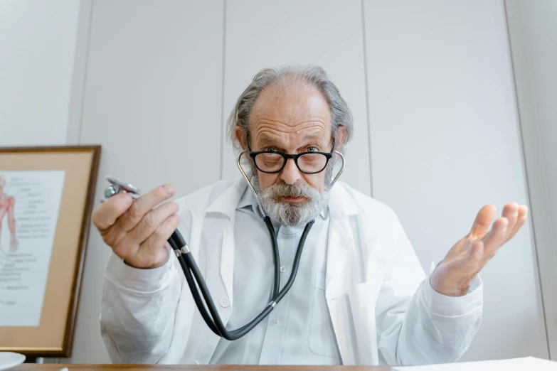 a doctor standing next to his desk in a hospital