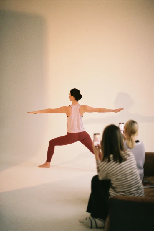 a man is doing a yoga pose in front of others