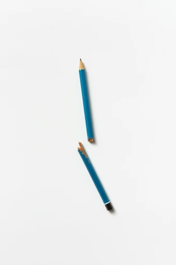 two pencils side by side on a white surface
