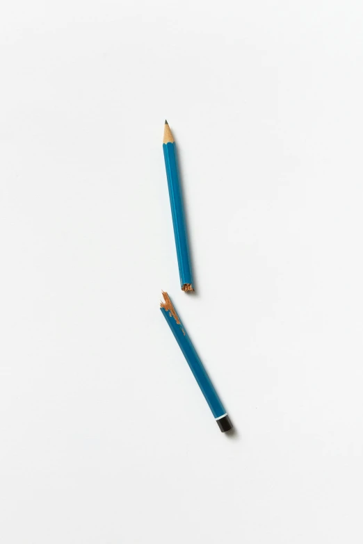 two pencils side by side on a white surface