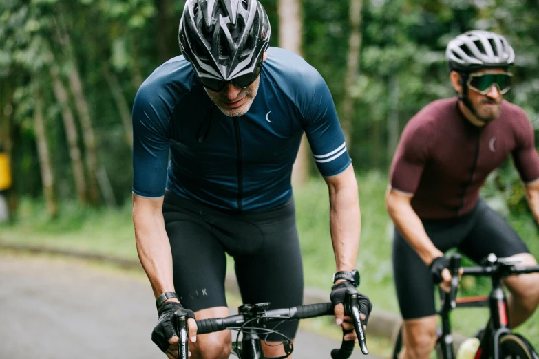 two bicyclists are taking part in a bike race