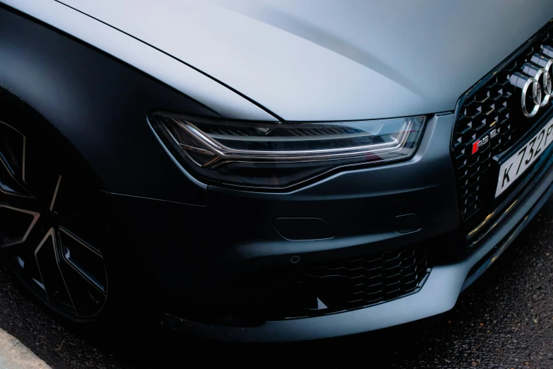 the front of an audi suv parked on a city street