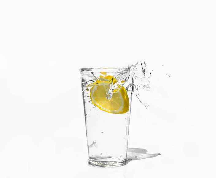 an orange wedges into a glass filled with water