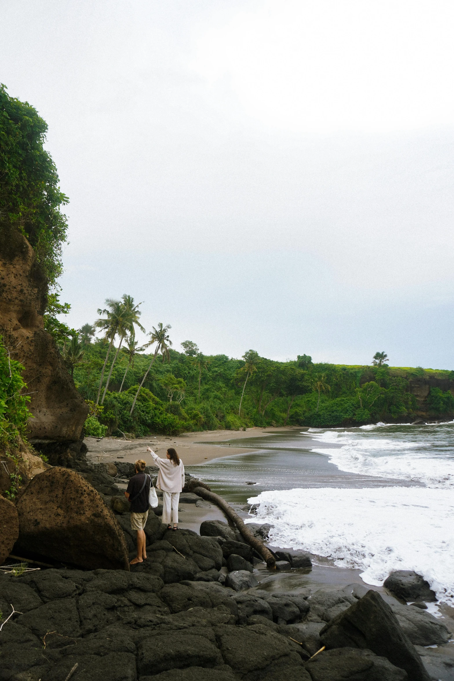 a man and woman looking out at the ocean