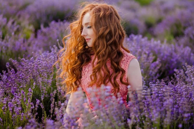 woman walking through a field of lavender in the spring