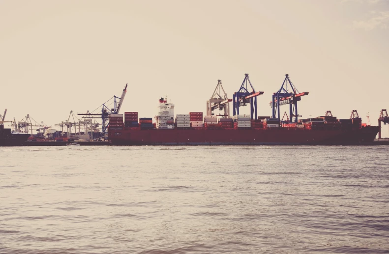 a large container ship at anchor in a harbor