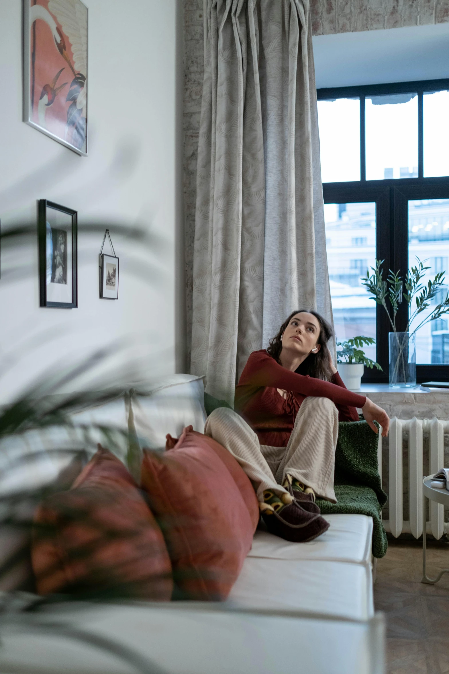 a woman sitting on a couch looking up