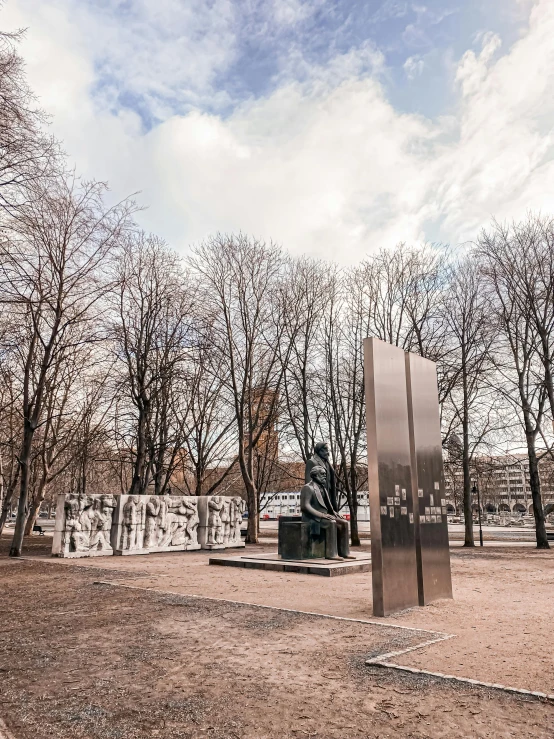 a metal sculpture in a field with trees