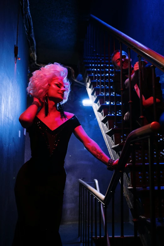 a person in a red and black dress and some stairs