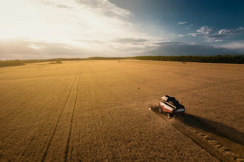 a man on a horse drawn plow working in a field