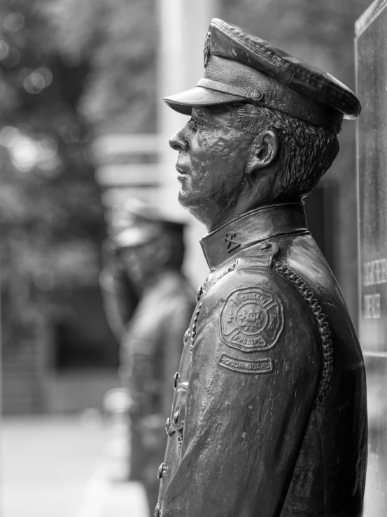 black and white po of statue at entrance to building