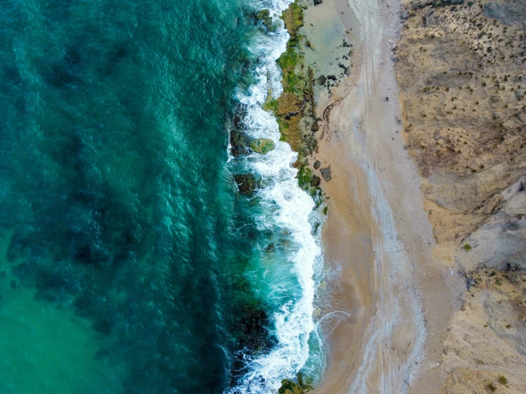 an aerial view of an ocean shoreline and shore line